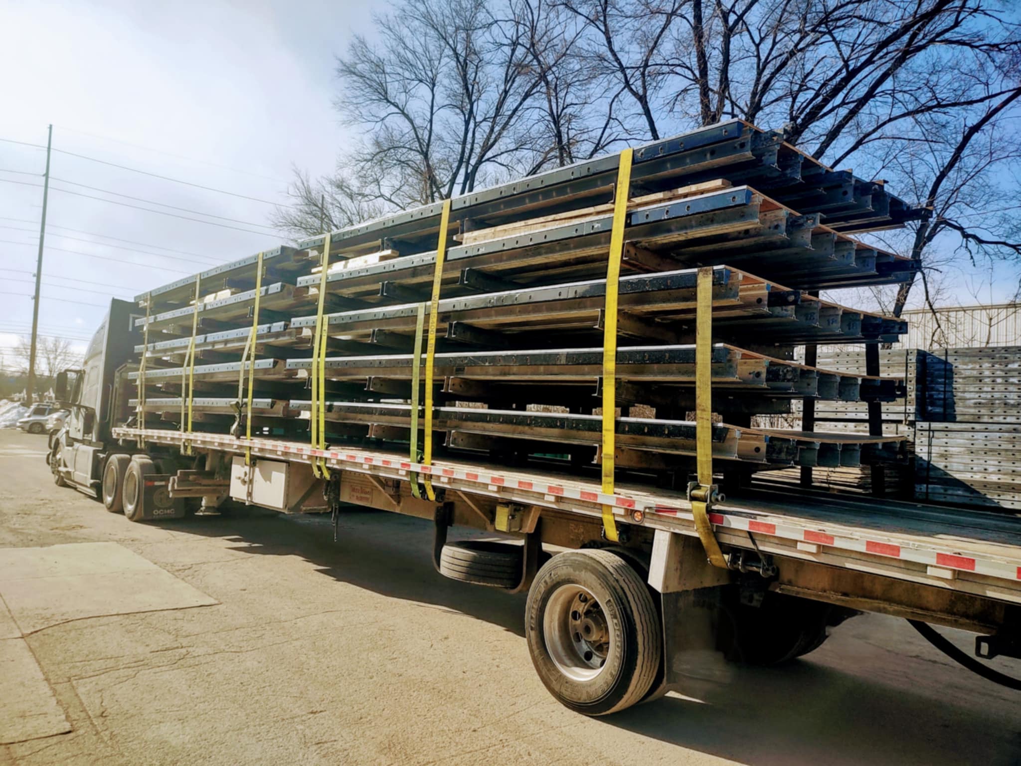 IHVI LLC flatbed trailer with a secured open-deck load