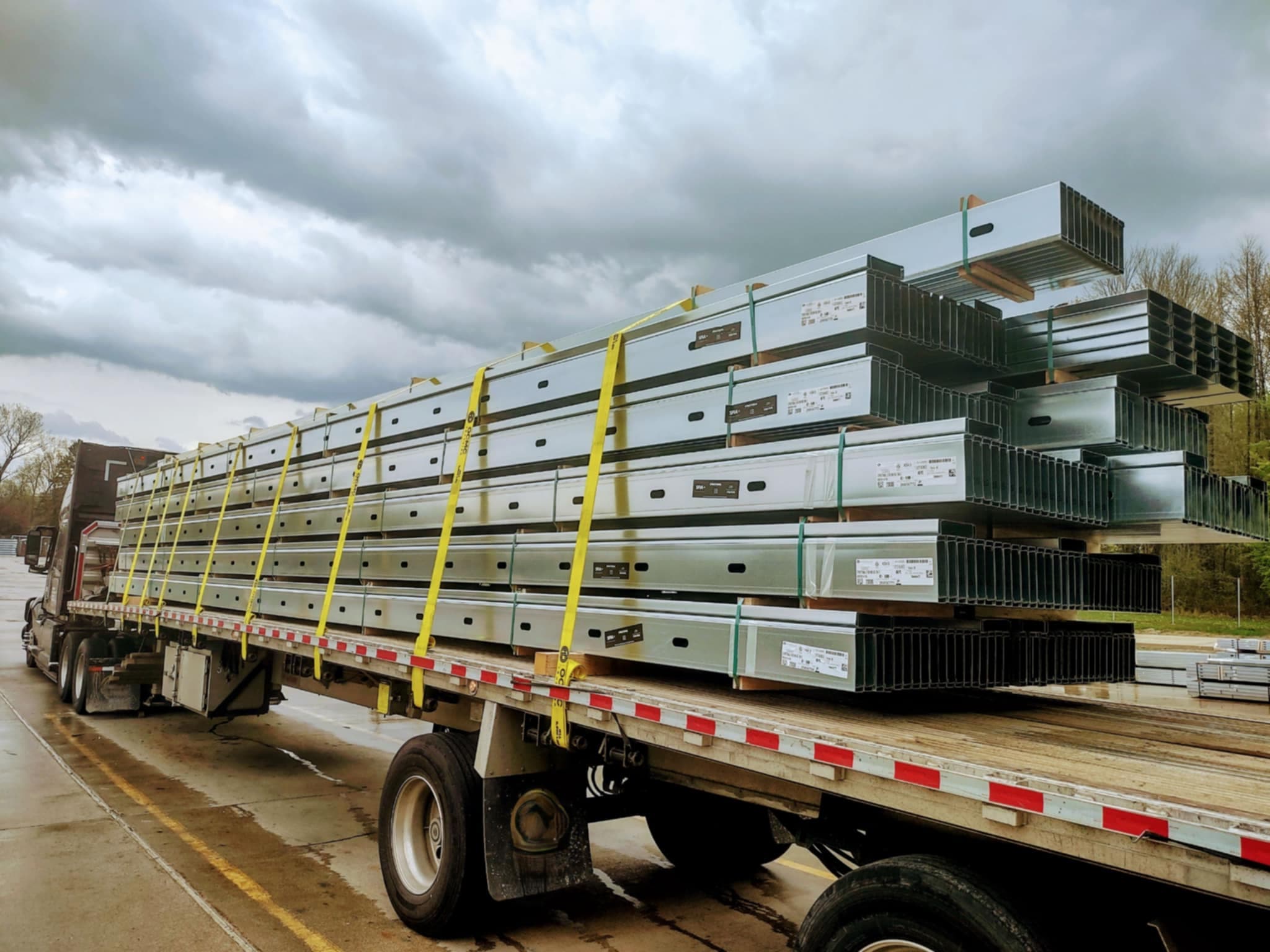 Galvanized steel building materials secured on a flatbed trailer