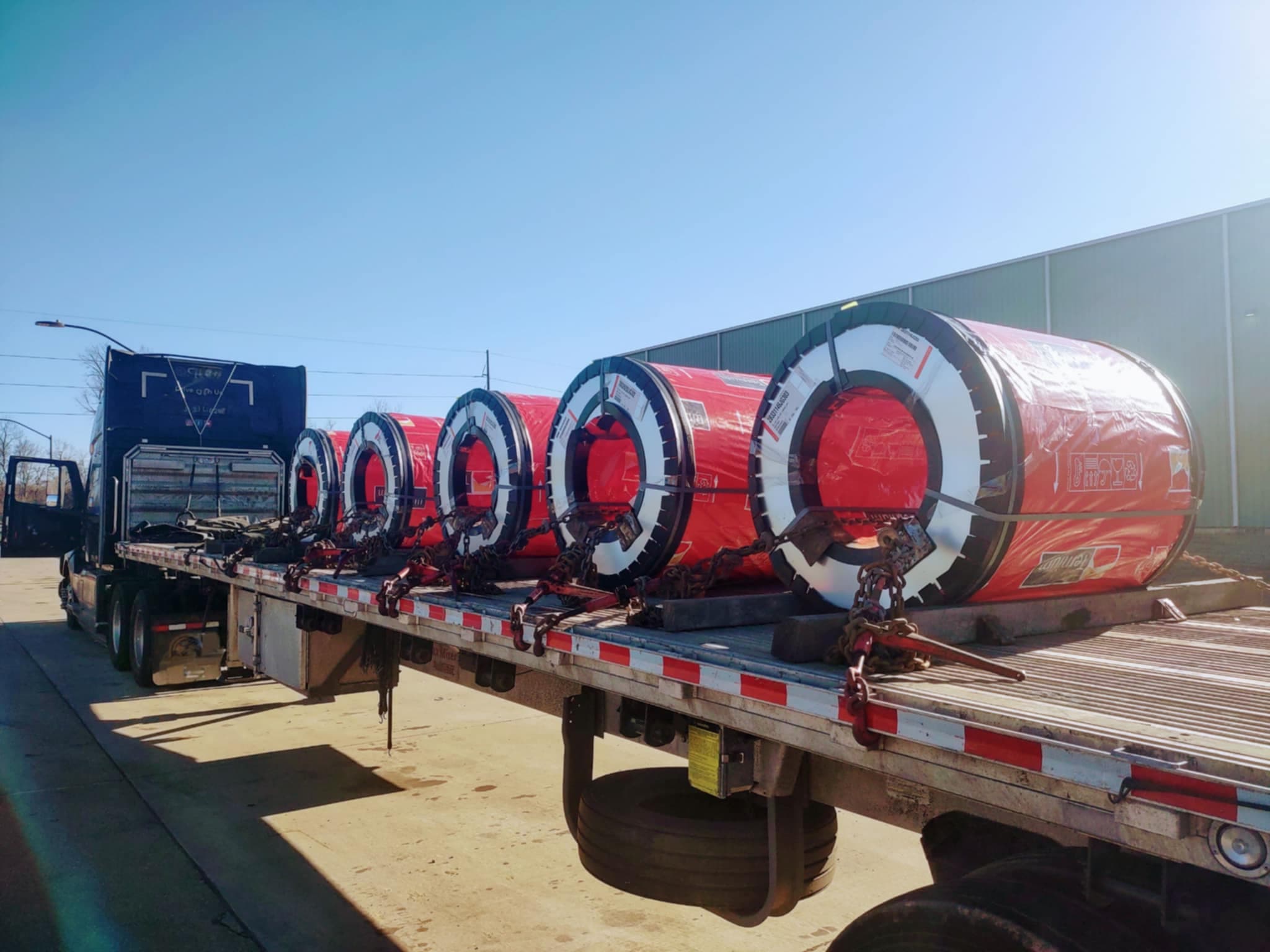 Industrial cargo secured on a flatbed trailer for equipment transportation